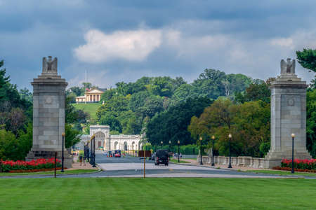 ARLINGTON,USA-AUGUST 31,2018: Entrance of Arlington National Cemetery in whose the dead of the nation's conflicts have been buried,beginning with the Civil War. J.F.Kennedy mansion in the background.のeditorial素材