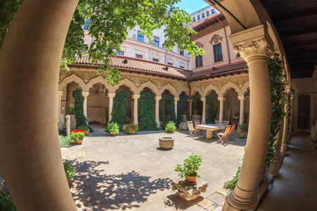 BUCHAREST, ROMANIA - JULY 16, 2018: The inner courtyard of Stavropoleos monastery, founded in 1724 by the Greek monk Ioanikia Stratonikeas, a masterpiece of Brancovan architectural style.のeditorial素材