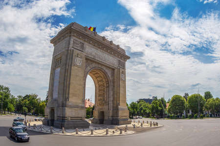 Bucharest, Romania - July 17, 2018: Triumphal Arch with flag, landmark architecture in the northern part of Bucharest, on the Kiseleff Road.のeditorial素材