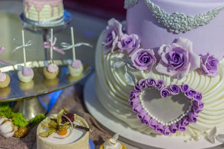 Wedding cake and specific sweets decorated with artificial flowers and painted.の写真素材