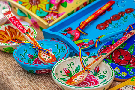 Spoons, bowls and wooden trays carved and painted with traditional Romanian patterns and used as...