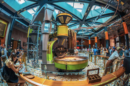 MILAN, ITALY - JUNE 29, 2019: Wide angle view of the interior of the Starbucks concept store in Milan, know as Starbucks Reserve Roastery, inside the historic Post building in Piazza Cordusio.のeditorial素材