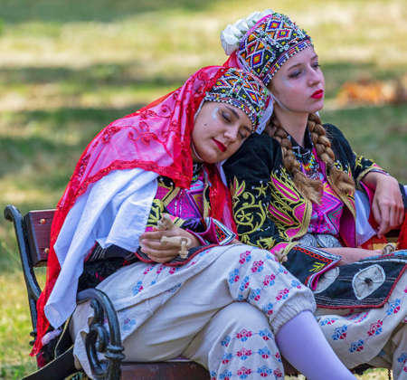 ROMANIA, TIMISOARA - JULY 7, 2019: Young girls from Turkey in traditional costume, present at the international folk festival, International Festival of hearts, organized by the City Hall. Funny atitude.のeditorial素材