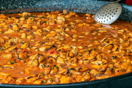 Background with mussel meat in a big pan and ready for cooking. Specific for mediterranean food.