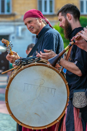 TIMISOARA, ROMANIA - SEPTEMBER 28, 2019: Men dressed in Hungarian medieval costumes and singing on...