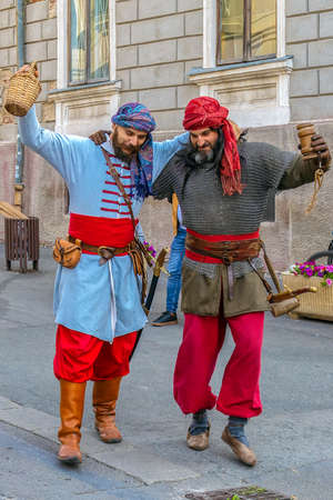 TIMISOARA, ROMANIA - SEPTEMBER 28, 2019: Men dressed in Turkish medieval infantry soldiers with uniform and dancing on the street, during the Days of hungarian culture, organized by the City Hall.のeditorial素材