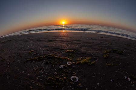 Black Sea beach in Mamaia, Romania. Sunset in July and view in fish eye lens.の写真素材