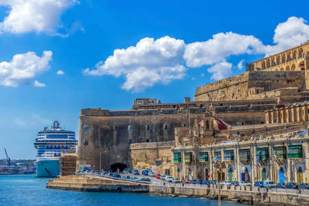VALLETTA, MALTA - MARCH 25, 2021: The Grand Harbor of Malta with cruise ship and typical old architecture.のeditorial素材