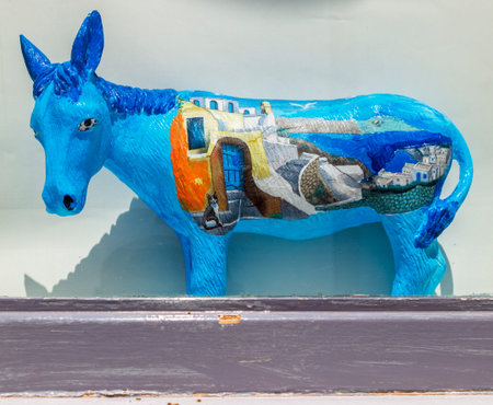 OIA, SANTORINI, GREECE - JUNE 21, 2021: Souvenir ornamental ceramic donkey, with specific drawings from Santorini. The donkey is the ancient means of transport and the symbol of the island.のeditorial素材