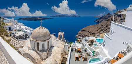 FIRA, SANTORINI ISLAND, GREECE - JUNE 21, 2021: Typical white architecture of Fira (Thira) city. Volcanic island Nea Kameni in background.のeditorial素材