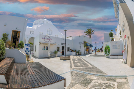 FIRA, SANTORINI, GREECE - JUNE 21, 2021: Small square with fashion shop, art galleries and restaurants near The Orthodox Metropolitan Church of Candlemas of the Lord, Cyclades.のeditorial素材