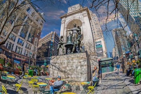 NEW YORK, USA - MARCH 7, 2020: Herald Square at intersection on 6th Avenue with Broadway and W 34th St. The James Gordon Bennett Monument with three statues and a bell, carved by AJP Carles.のeditorial素材