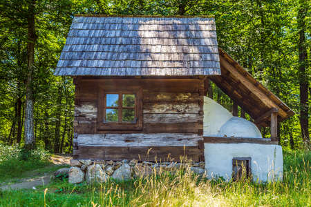 SIBIU, ROMANIA - JULY 9, 2020: Old traditional romanian house. Located at the Museum of Traditional Popular Civilization (Astra) Sibiu, the largest open-air museum in Romania.のeditorial素材