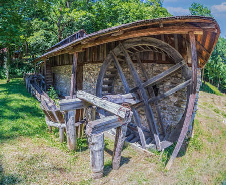 SIBIU, ROMANIA - JULY 9, 2020: Old traditional romanian watermill with Two Filling Cylinders and Two Whirlpools. Museum of Traditional Popular Civilization, the largest open-air museum in Romania.のeditorial素材