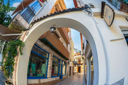 BENIDORM, SPAIN - AUGUST 14, 2020: View with small and picturesque street with shops, located in the historical center of the city.のeditorial素材