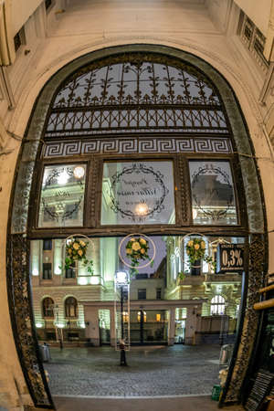 BUCHAREST, ROMANIA - NOVEMBER 26, 2019: Street view from Mocca-Villacroix passage, one landmark point in the town from 1891. National Bank of Romania, from 1880, in the background.のeditorial素材
