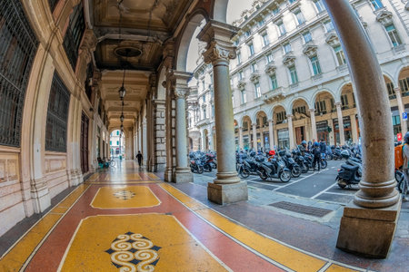 GENOA, ITALY - MARCH 20, 2021: Street view with old buildings on Via Francesco Petrarca and typical motorcycle scooter parking. Historic center of the city.のeditorial素材