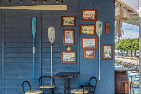 UMAG, CROATIA - JUNE 7, 2022: Wooden wall of one rowing club building, decorated with old pictures...