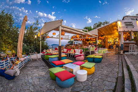SKIATHOS TOWN, SKIATHOS ISLAND, GREECE - AUGUST 22, 2023: View of a funny colored tavern, in the Greek Mediterranean architecture of the old town.のeditorial素材