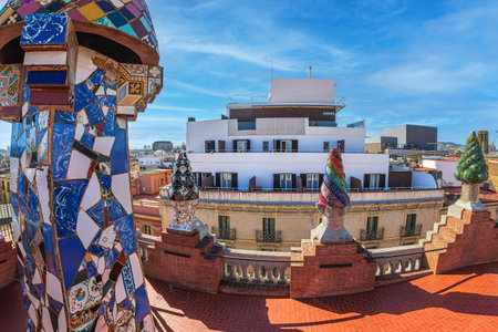 BARCELONA, SPAIN - APRIL 14, 2024: Original chimneys covered with ceramics of different colors on the roof of the Palau Guell designed by architect Antoni Gaudi. Built 1886-1888, UNESCO.のeditorial素材
