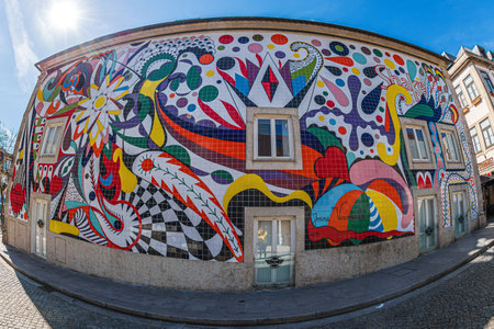 PORTO, PORTUGAL - APRIL 11, 2024: Beautiful facade of a house on R. de SÃ¡ de Noronha street, decorated with a modern artwork in the local technique of decorated ceramics called Azulejos.のeditorial素材