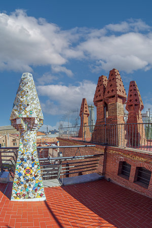 BARCELONA, SPAIN - APRIL 14, 2024: Original chimneys covered with ceramics of different colors on the roof of the Palau Guell designed by architect Antoni Gaudi. Built 1886-1888, UNESCO.のeditorial素材