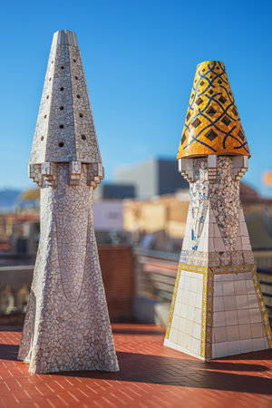 BARCELONA, SPAIN - APRIL 14, 2024: Original chimneys covered with ceramics of different colors on the roof of the Palau Guell designed by architect Antoni Gaudi. Built 1886-1888, UNESCO.のeditorial素材