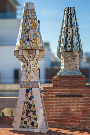 BARCELONA, SPAIN - APRIL 14, 2024: Original chimneys covered with ceramics of different colors on the roof of the Palau Guell designed by architect Antoni Gaudi. Built 1886-1888, UNESCO.のeditorial素材