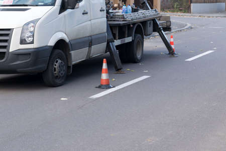 warning orange and white cones pretecting men at workの写真素材