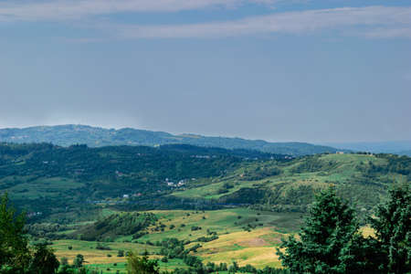 Scenic view of green hills covered in grass and vegetationの写真素材
