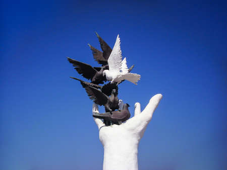 Kusadasi, Turkey - June 17 2012 : sculpture, hand, black and white dove in Kusadasi, Turkey. Hand of peace monument.のeditorial素材