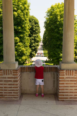 Mogosoaia, Romania - August 05, 2018: young girl looking at the alley entrance at Mogosoaia Palace near Bucharest, Romania.のeditorial素材