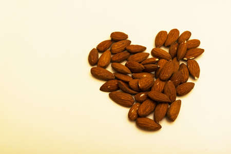 almonds arranges in a heart shape - healthy food conceptの写真素材