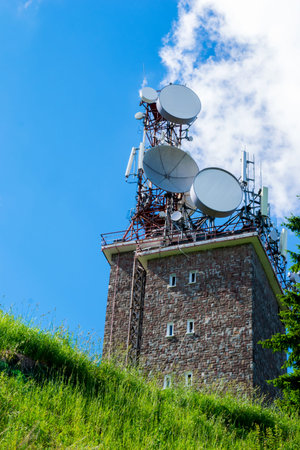 big wireless communication antennas mounted on top of utility building
