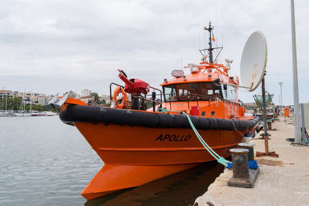 Constanta, Romania - August 14, 2019: Orange fireman boat docked at Constanta port, Romania.のeditorial素材