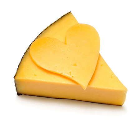 Cheese and heart from cheese isolated on white backgroundの写真素材