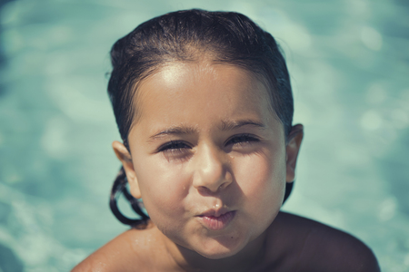 The little Italian girl playing in the pool in the summerの写真素材