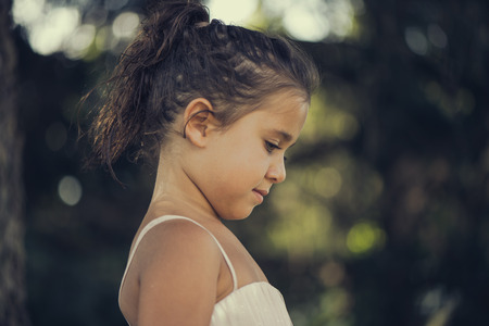 little girl in a pink ballroom dress on natureの写真素材