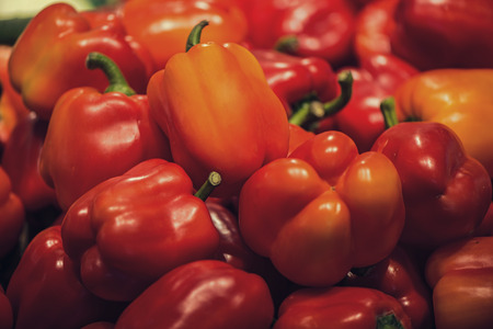Red bell peppers in containers in the supermarket. A large number of red peppers for sell. Food backgroundの写真素材