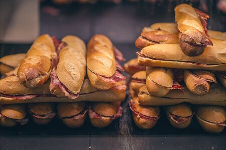 French loaf with Spanish jamon. Spanish Iberico Jamon. Traditional Spanish Ham. Thin slices of the Iberico jamon between two pieces of breadの写真素材
