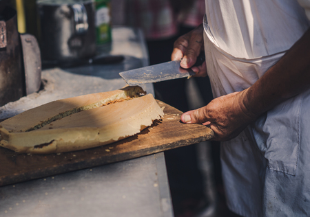 A man is cooking a pie in the market of chinatown, Malaysia. Street food.の写真素材