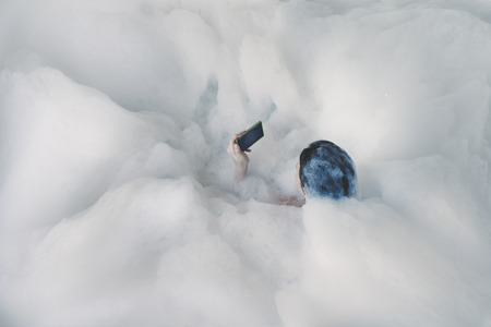 Naked young woman with a large hot tub in foam. Girl in the foam in the bathroomの写真素材