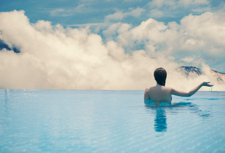 Young female in the pool on the roof of the Tyrolの写真素材