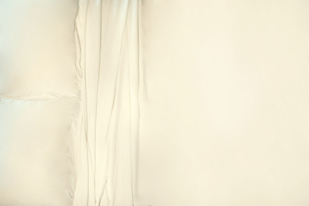 Bed with white soft pillows covered with white cotton sheets. Top viewの写真素材