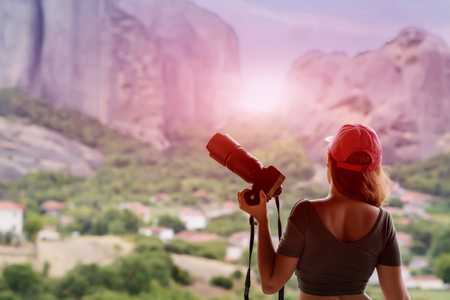 Female in red cap with camera. Meteora, Greeceの写真素材