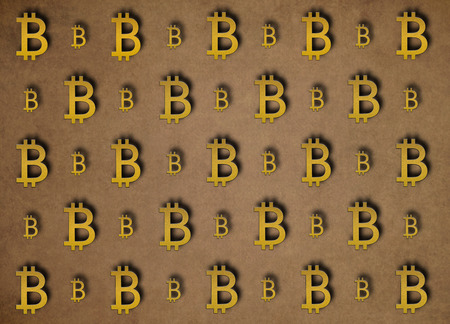 Texture of sign crypto currency of bitcoin on gold background. Symbol BTC. Bitcoin bifurcationの写真素材