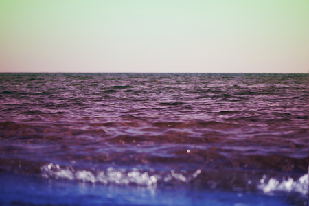 Background of ocean and texture sea water on sunset different colorの写真素材