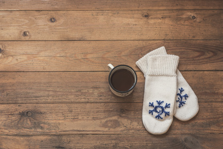 iron mug with coffee and knitted mittens on the wooden floor. Winterの写真素材