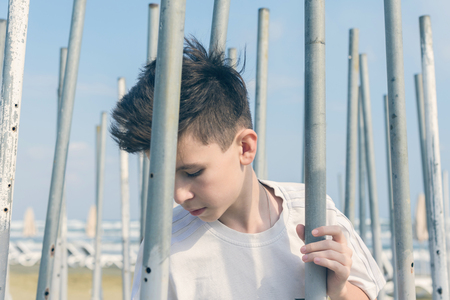 The boy playing and trying to find a way out of the maze of iron pipes.の写真素材