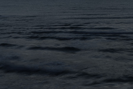 Aerial view of the sea wave with a long exposure at nightの写真素材